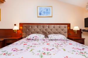 a bedroom with a large bed with two pillows at Nonna Marija 1 in Rovinj