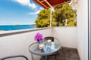 a table with a vase of flowers on a balcony at Nonna Marija 1 in Rovinj