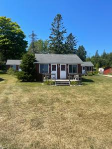 a house with a large yard in front of it at FireHouse Inn in Saint Ignace