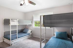 a bedroom with two bunk beds and a window at Pine Whiff Gardens in Annapolis