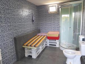 a bathroom with a bench and a shower and a toilet at Refúgio Singelo in Espinho +13 photos