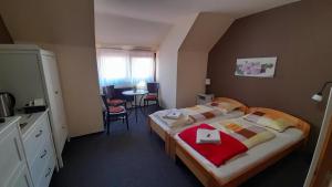 a hotel room with a bed and a table at Jasmin Privatzimmer in Murau