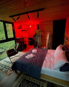 a bedroom with a bed in a room with red lighting at Pirdapira in Jut'a
