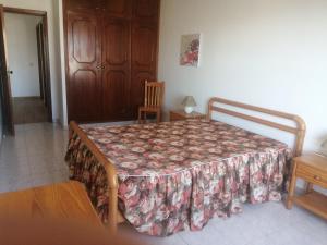 1 dormitorio con cama con colcha en T1 em Alvor, en Alvor