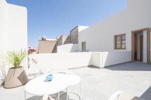 a white balcony with a white table and chairs at I MORI HOTEL in San Vito lo Capo