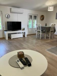 a living room with a tv and a table with remotes at Mia Casa in Tivat