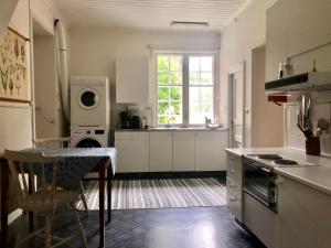 a kitchen with a sink and a stove top oven at Borgviks herrgårdsflygel in Borgvik