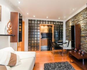 a living room with a white couch and a table at Aquarium House in Sesimbra