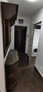 a hallway with a bench in a room with a washing machine at Mara Park in Baia Mare