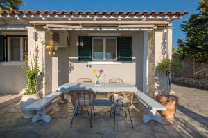 a table and chairs in front of a house at La Villetta in Lagópodhon
