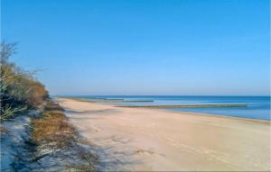 a sandy beach with the ocean in the background at 2 Bedroom Lovely Home In Sianozety in Sianozety