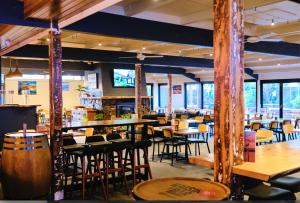 a restaurant with tables and chairs and a bar at Mallacoota Hotel Motel in Mallacoota