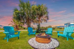 a group of chairs sitting around a fire pit at Luxury Ocean Blue beach house- 3 bed room Dog friendly in Palm Coast