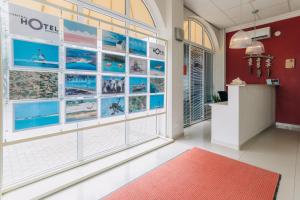 a room with a large window and a red rug at Central Hotel Bonaire in Kralendijk