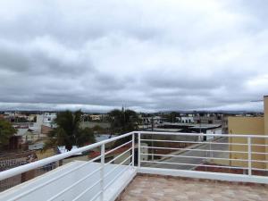 a balcony with a view of a city at Hostal Las Orquideas in Manta