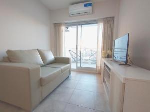 a living room with a couch and a television at Depto Moreno in Rosario