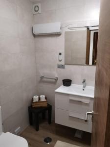 a white bathroom with a sink and a mirror at Residencia Vista Alegre in Santiago de Compostela