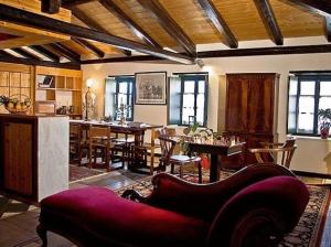 a living room with a couch and a dining room at Lazareto Hotel in Monemvasia