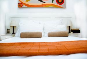 a bedroom with a white bed with two pillows at Cape Nelson Guest House in Cape Town +23 photos