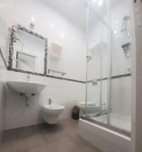 a bathroom with a toilet and a sink and a shower at B&B Ammirata in Palermo +48 photos