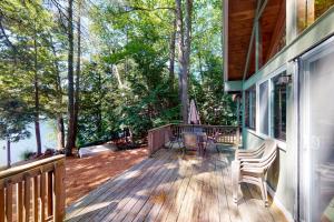 a large deck with a view of the water at Cabin on Long Pond in Cornish
