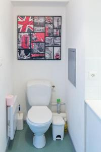 a bathroom with a toilet and a picture on the wall at Part-Dieu Lyon Appart in Lyon