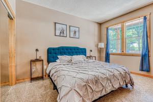 a bedroom with a blue bed and a window at Second Chair Inn in Rhododendron +28 photos