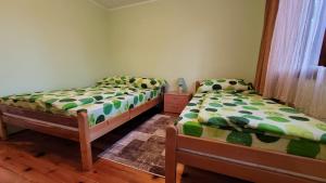 two twin beds in a room with at Apartman Panorama in Mokra Gora