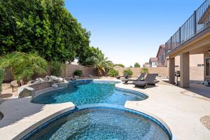 a swimming pool in the middle of a yard at Desert Dazzle in Peoria