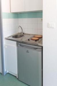 a small kitchen with a sink and a stove at studio part dieu in Lyon