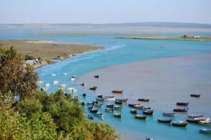 a group of boats in a body of water at Maison Moulay! in Moulay Bousselham