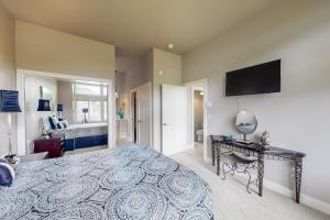 a bedroom with a large bed and a flat screen tv at South Pacific Escape 1 & 2 in Rockaway Beach