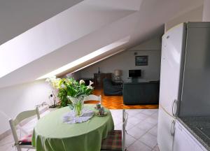 uma sala de estar com uma mesa verde com flores em Apartment Fiumara em Rijeka