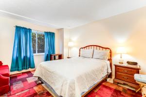 a bedroom with a large bed and blue curtains at Linville Golf and Ski in Newland