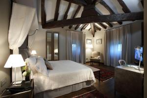 a bedroom with a bed and a tv in a room at Iriarte Jauregia Hotel in Bidegoian