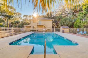a swimming pool in front of a house at Dunes Villas in Hilton Head Island