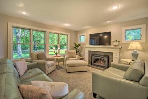 a living room with couches and a fireplace at Charming Taylors Falls Home with Deck, Fire Pit in Saint Croix Falls