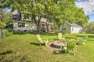 a group of lawn chairs sitting in a yard at Charming Taylors Falls Home with Deck, Fire Pit in Saint Croix Falls