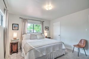 a bedroom with a bed and a window and a chair at Lake Powell Views Mid-Century Home in Page in Page