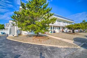 a tree in a parking lot in front of a building at Beautiful Brigantine Condo - Walk to Beach! in Brigantine