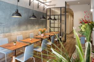 a restaurant with wooden tables and blue chairs at B&B Governo dei Nove in Siena