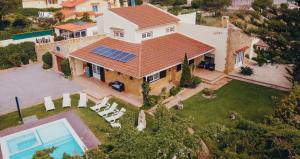 an aerial view of a house with solar panels on the roof at Villa Tumbine in Cascais +52 photos