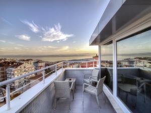 a balcony with chairs and a table on a building at Fesa Business Hotel in Gebze