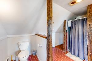 a bathroom with a toilet in a room at Harbor Myst in Gouldsboro