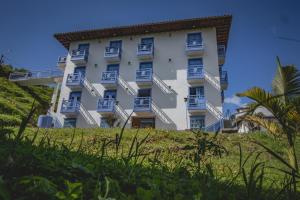 a large white building on top of a hill at Apartahotel Villa carolina 1 in Jericó