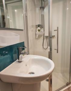 a bathroom with a white sink and a shower at Heart of Kerikeri - The Studio in Kerikeri