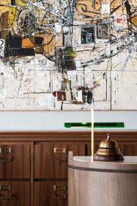 a table with a candle in front of a wall at Hotel Costanero MGallery - ACCOR in Montevideo