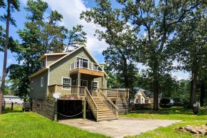 a house with a deck and stairs leading up to it at Tree Frog KDH920 in Kill Devil Hills