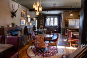 a dining room with a table and chairs and a fireplace at Kings Arms in Bradford on Avon