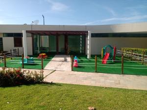 a building with a playground in front of a building at Praia dos Carneiros Flat 206 C in Tamandaré
